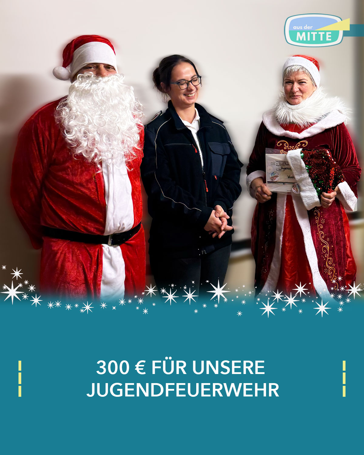 Leiterin der Jugendfeuerwehr Binz gemeinsam mit Weihnachtsmann und Weihnachtsfrau