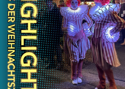 Besucher auf dem Weihnachtsmarkt Engel, Licht und Meer im Kurpark Binz bei beleuchteten Animateuren